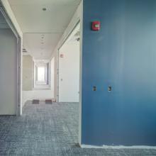 Interior hallway under construction with a blue wall