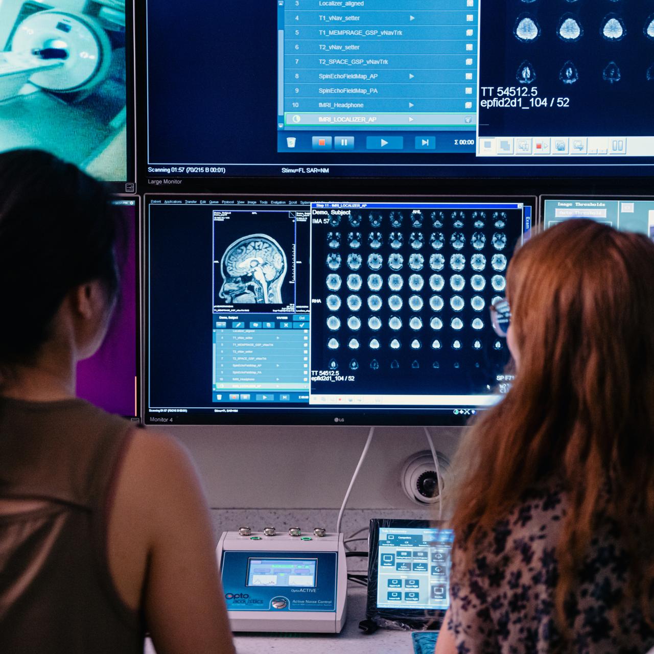 Two researchers sitting together reading the results of an MRI scan