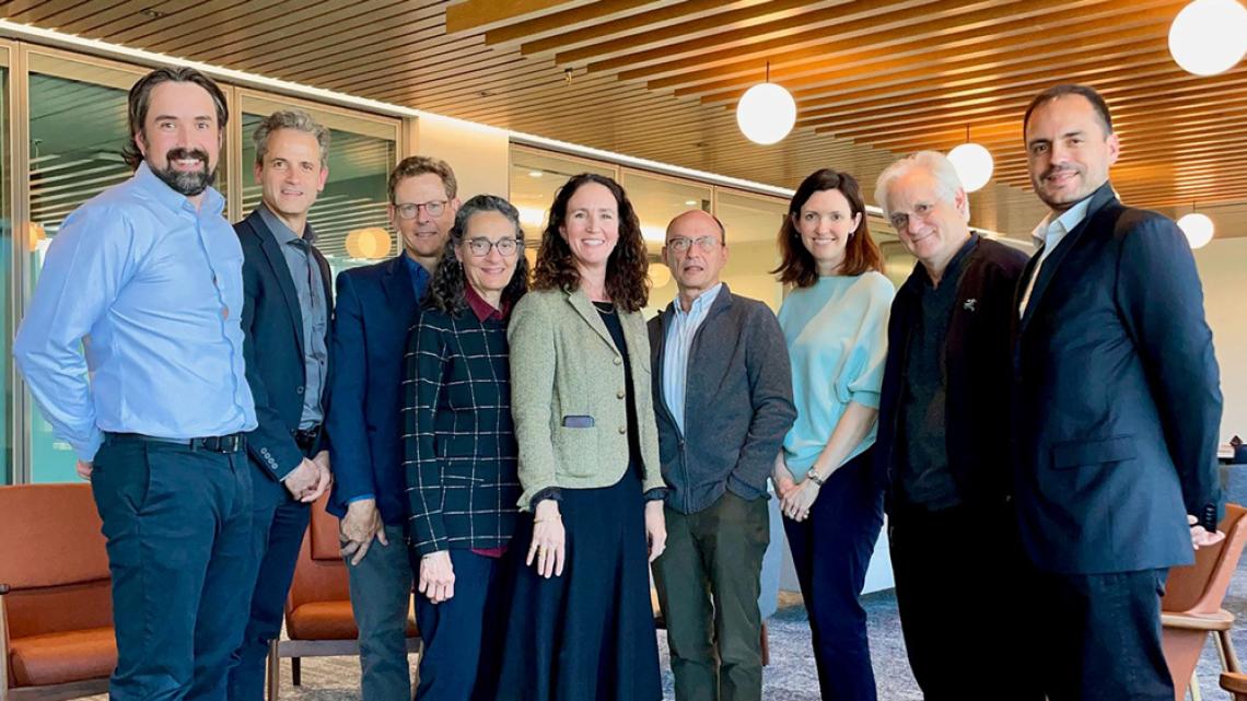 WTI External Advisory Board meeting; nine people standing together in a meeting space.